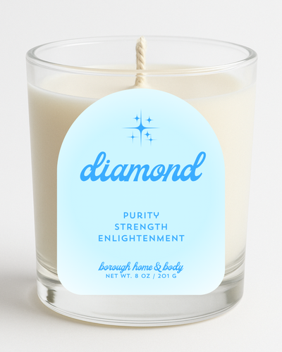 Front view of April Diamond Birthstone Candle with white and silver-toned label, in an 8 oz clear glass jar on a white background.