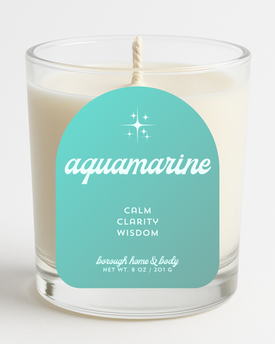 Front view of March Aquamarine Birthstone Candle with soft blue label, in an 8 oz clear glass jar on a white background.