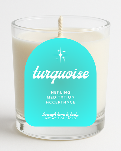 Front view of December Turquoise Birthstone Candle with turquoise blue label, in an 8 oz clear glass jar on a white background.