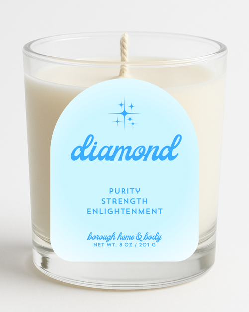 Front view of April Diamond Birthstone Candle with white and silver-toned label, in an 8 oz clear glass jar on a white background.