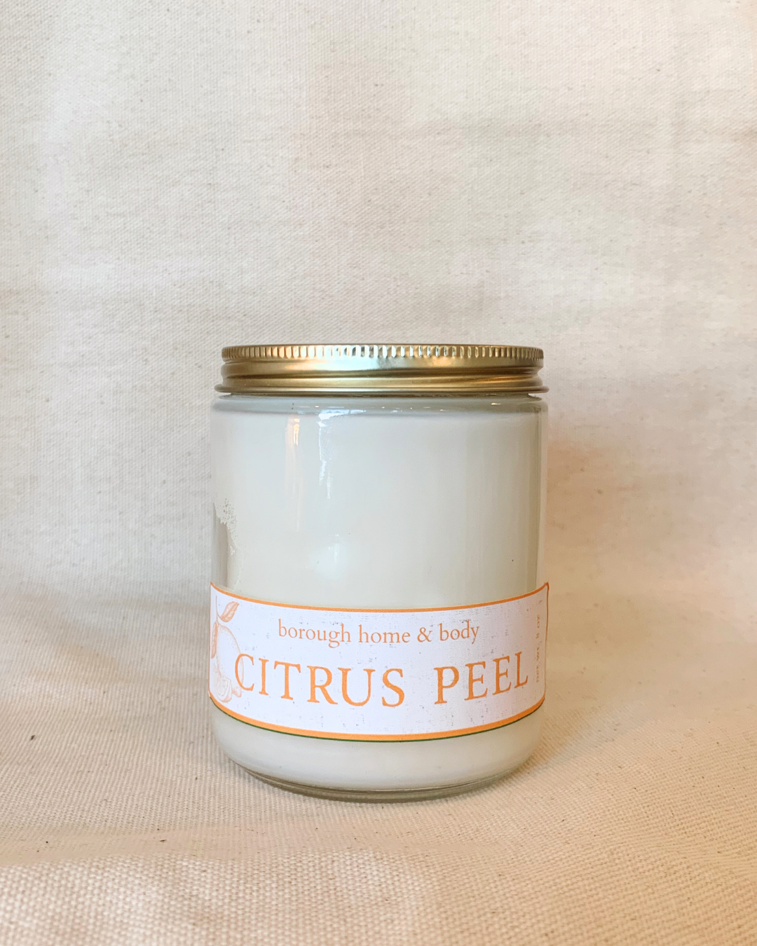Citrus Peel scented candle in clear glass jar with gold lid, Botanical Collection, hand-poured soy wax with orange zest and rind fragrance
