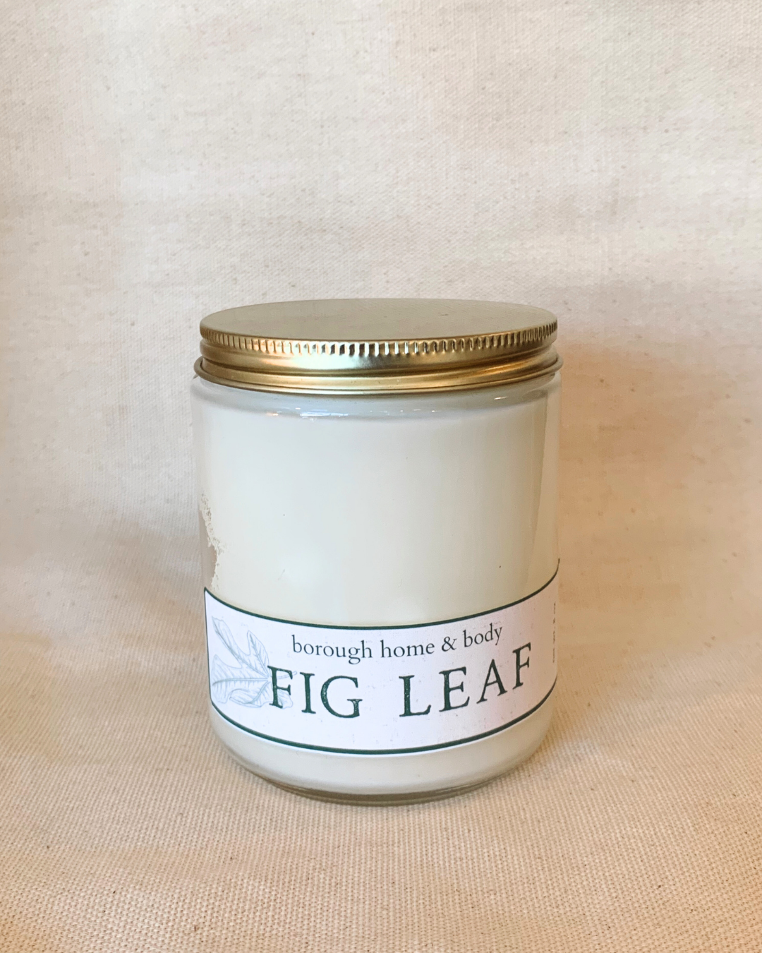 Fig Leaf scented candle in transparent glass vessel with gold screw-on lid, Botanical Collection, natural soy wax and earthy green fragrance