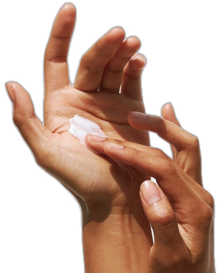 Two hands with one hand applying cream to the other on a white background