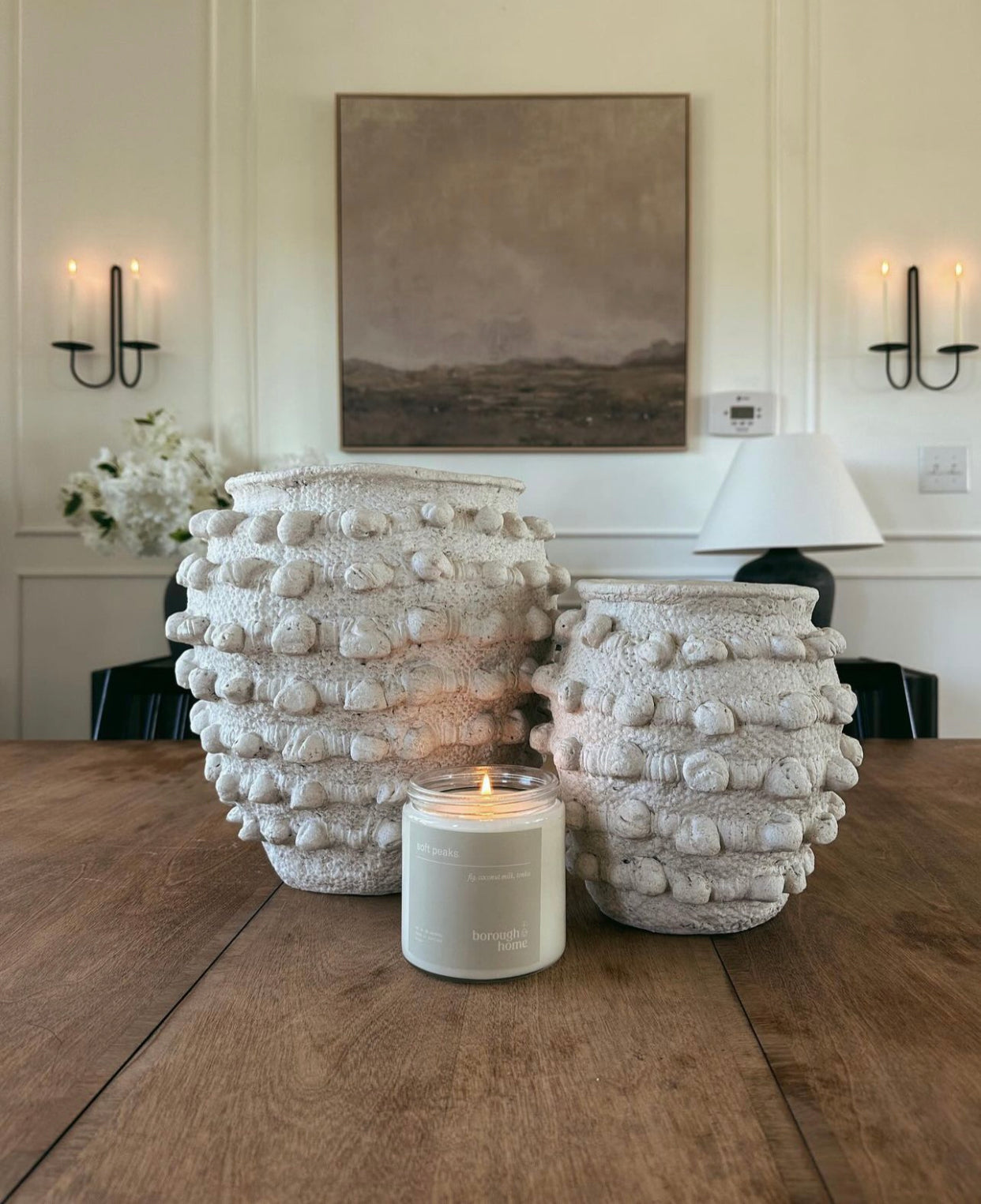 Soft Peaks candle styled on dining table, front view.