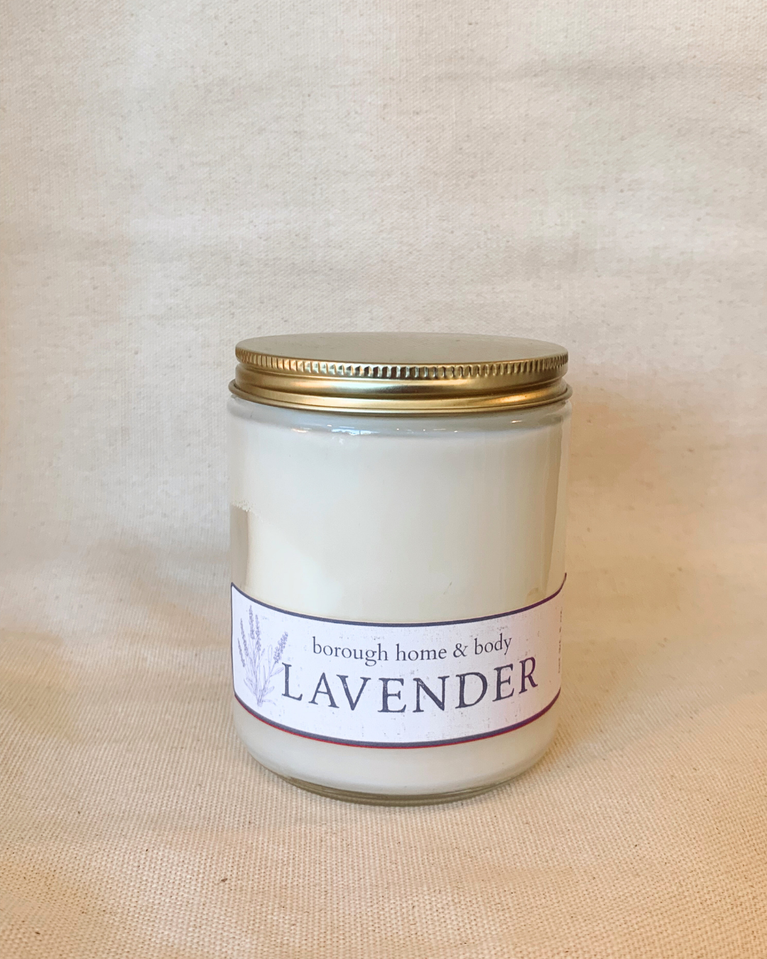 Lavender candle in minimalist glass container with gold lid, soy wax blend with clean floral and herbal scent from Botanical Collection
