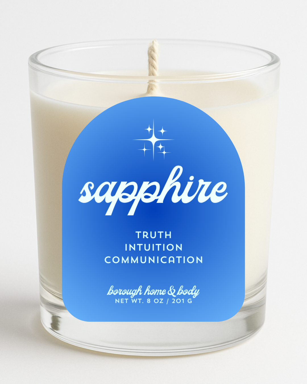 Front view of September Sapphire Birthstone Candle with deep blue label, in an 8 oz clear glass jar on a white background.