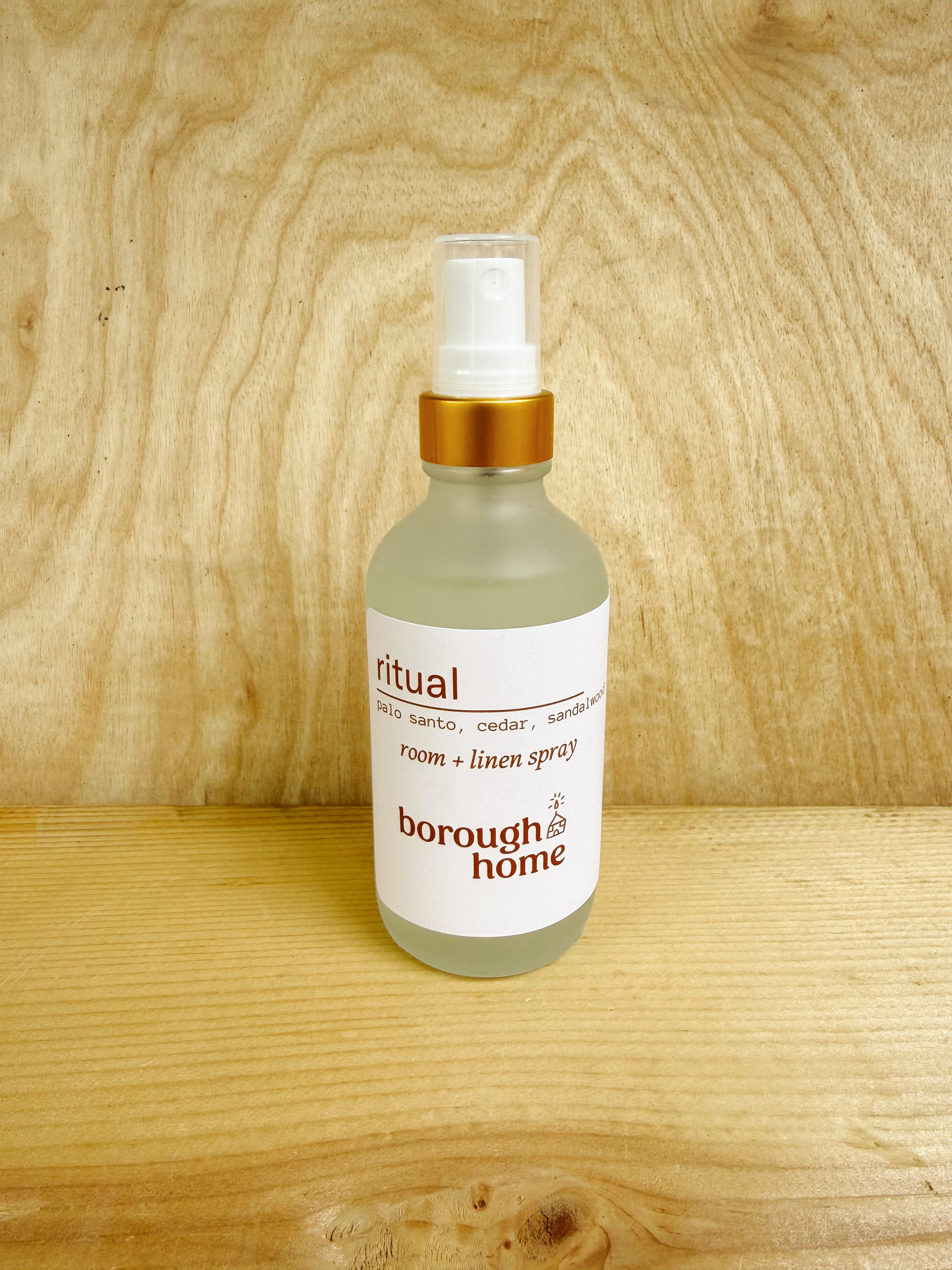 Bottle of 'ritual' room and linen spray by Borough Home on a wooden surface