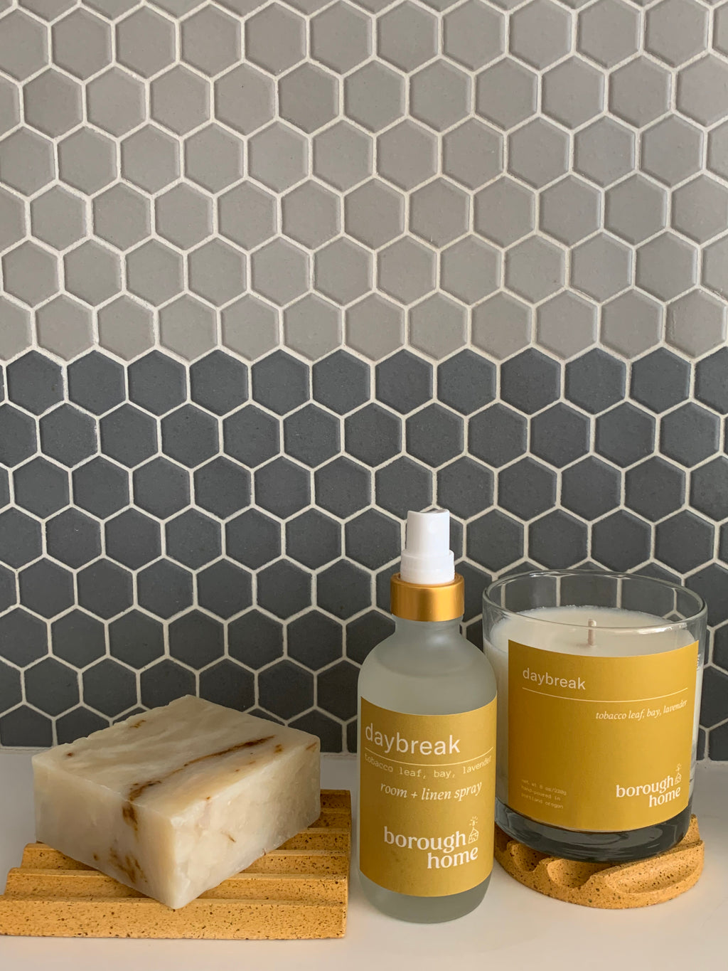 Daybreak Bath and Body Collection, with bar soap, room spray and candle, front view.