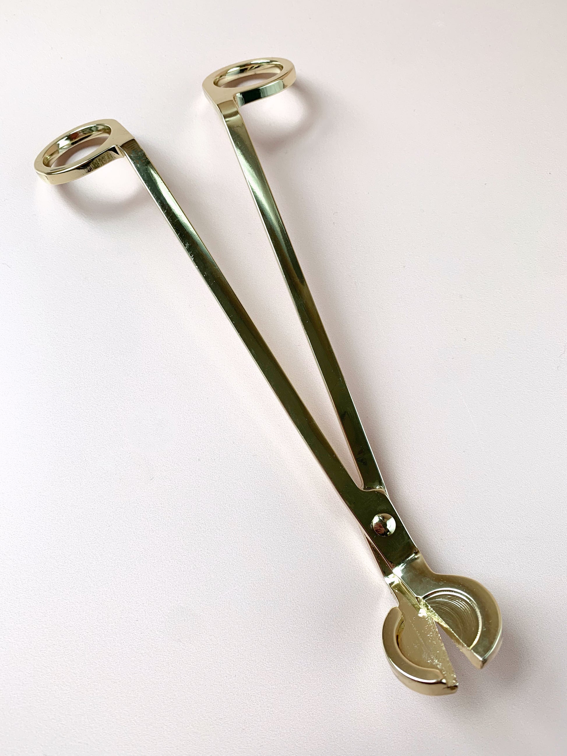 wick trimmer in gold, top down view